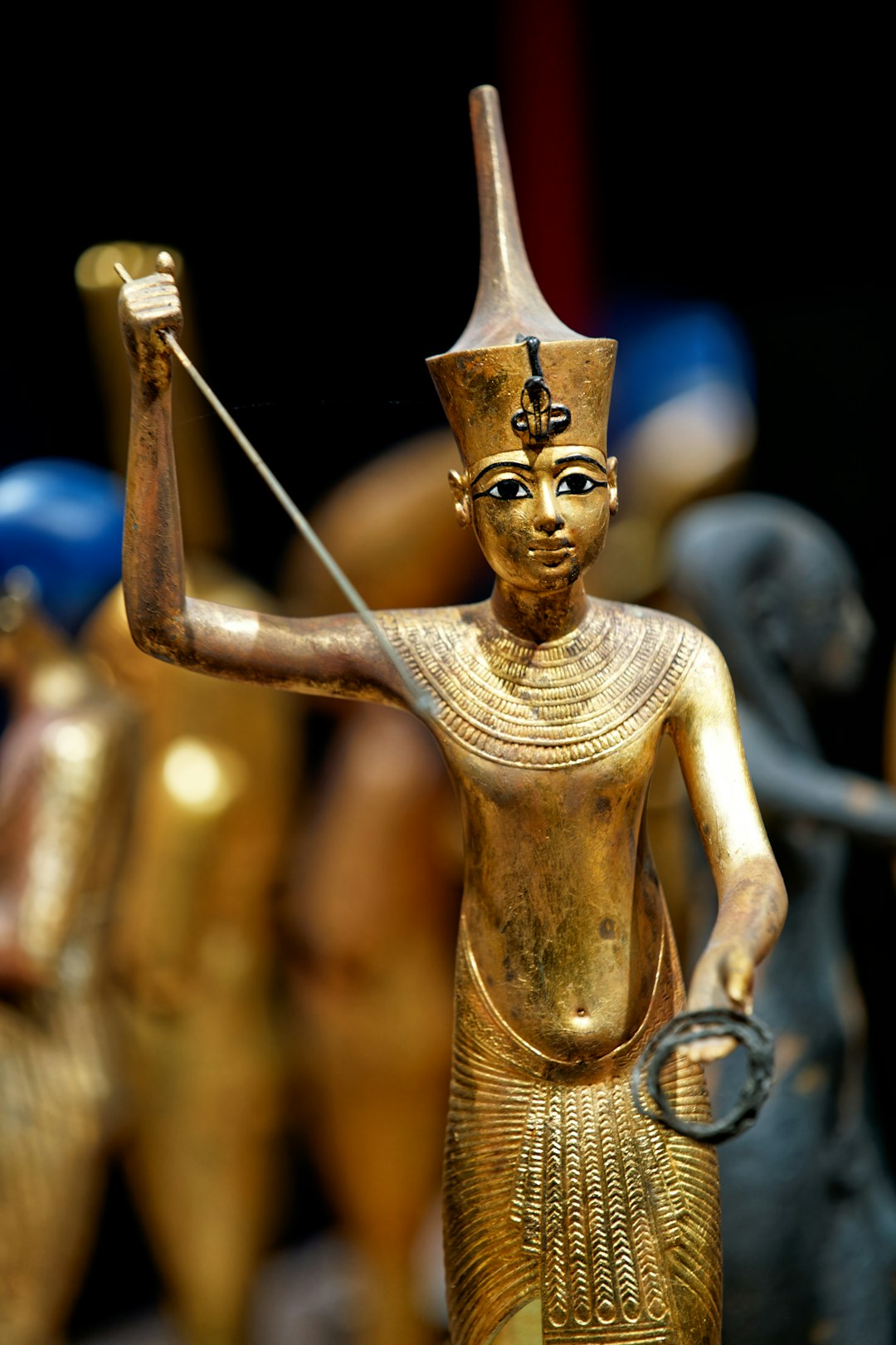 a-statue-of-an-egyptian-god-holding-a-staff-hgb2utvbikk